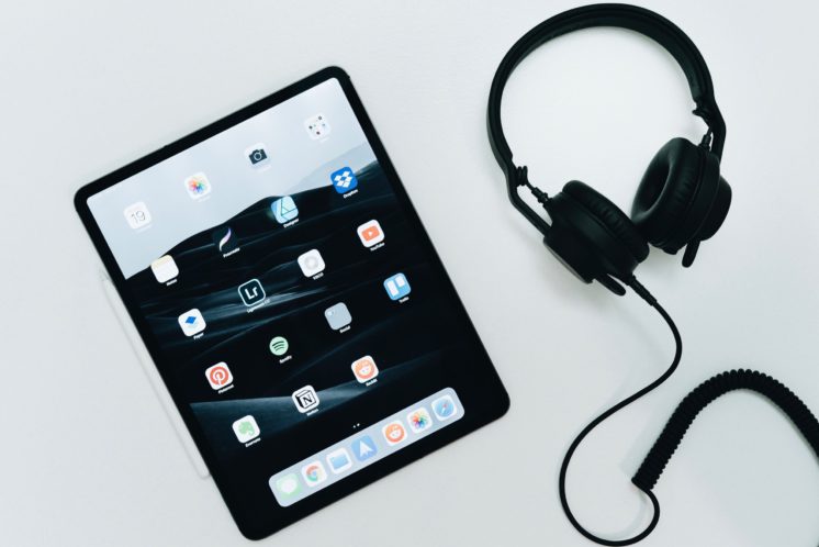 iPad and headphones on a white table