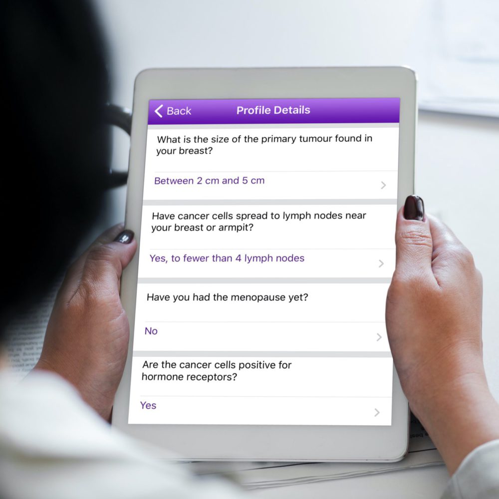 A woman answering OWise profile detail questions on an iPad